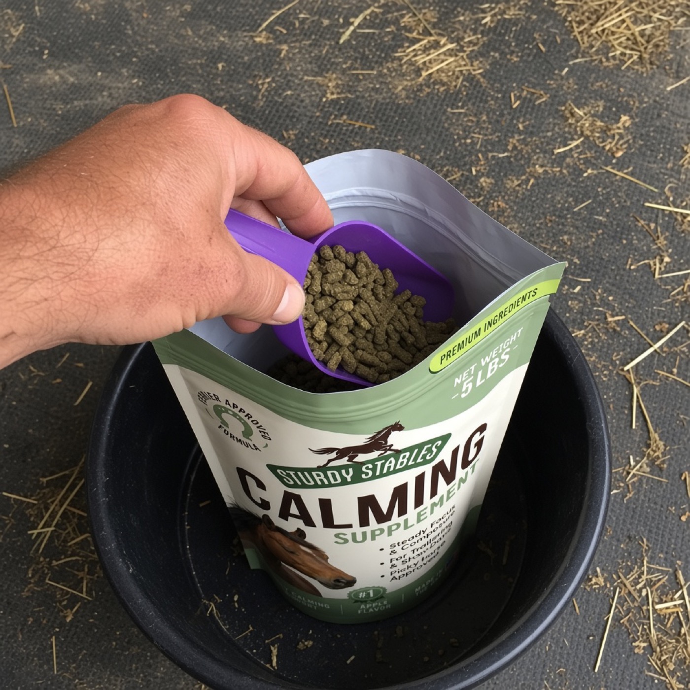 Scooping calming pellets into a feed tub